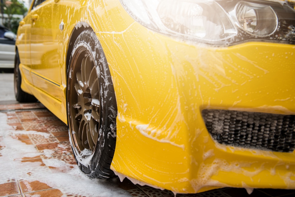 How to Protect Your Car’s Paint from Pollen and Spring Weather 1 Car washing, cleaning car using high pressure Water on front yellow car.