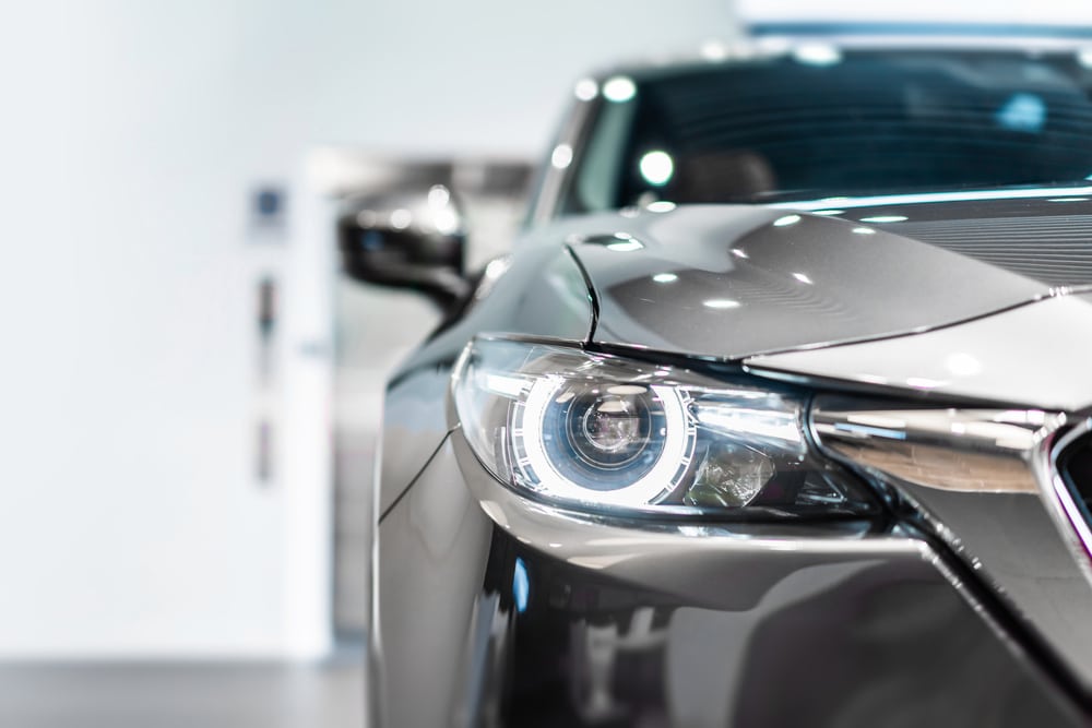 front view of new modern silver car led headlight in showroom